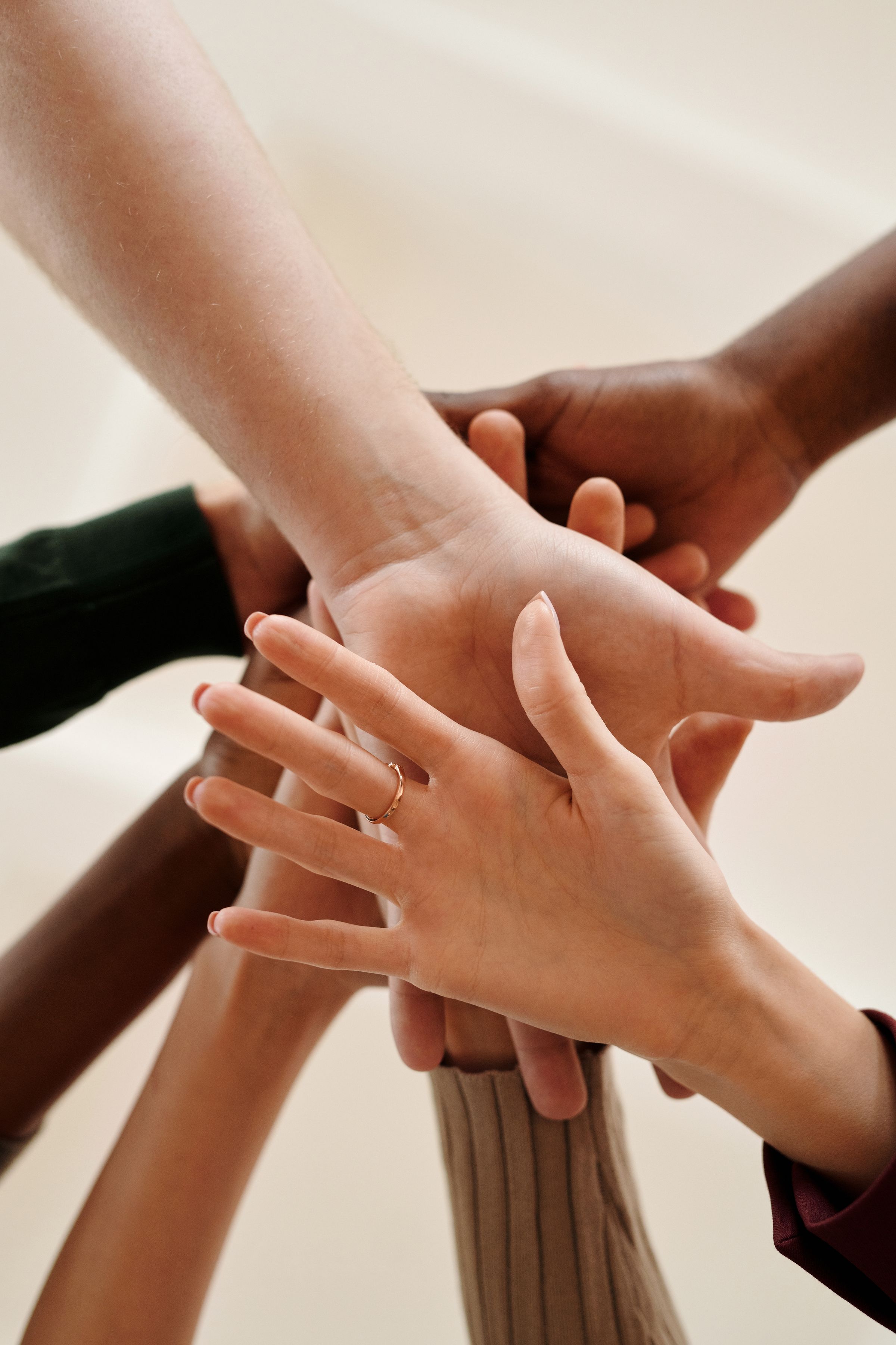 A group of people joining hands together in unity
